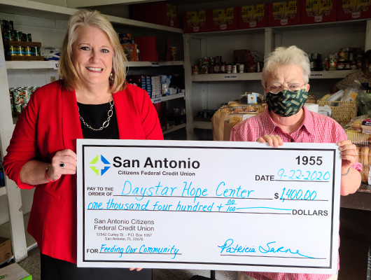 SACFCU's president - Patty Sarne presenting a check for $1,400 to Daystar Hope Center