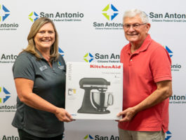 Picture of the Dade City Branch Manager along with the winner of SACFCU's Mobile Banking Contest. Both of them are holding up the price of a Kitchenaid Stand Mixer