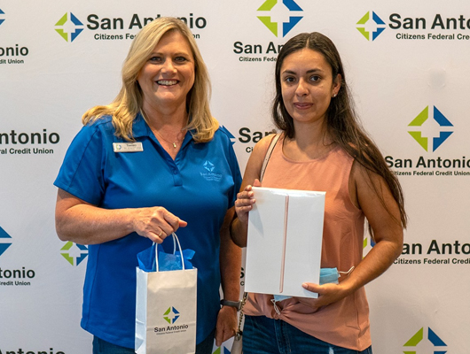 Picture of the Dade City office Area Manager, Tammy Minton presenting Sandra Gonzalez with an iPad
