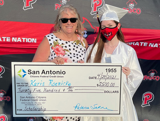 Picture of SACFCU's CEO presenting Karis Roenicke with a $2,500 Scholarship check