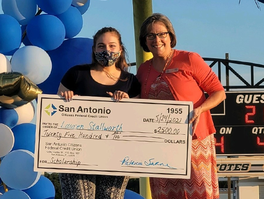 Picture of SACFCU's CEO presenting Lauren Stallworth with a $2,500 Scholarship check