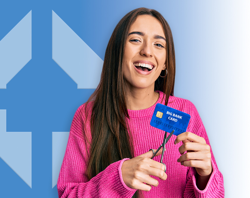 Picture of a girl getting ready to cut a credit card with scissors.