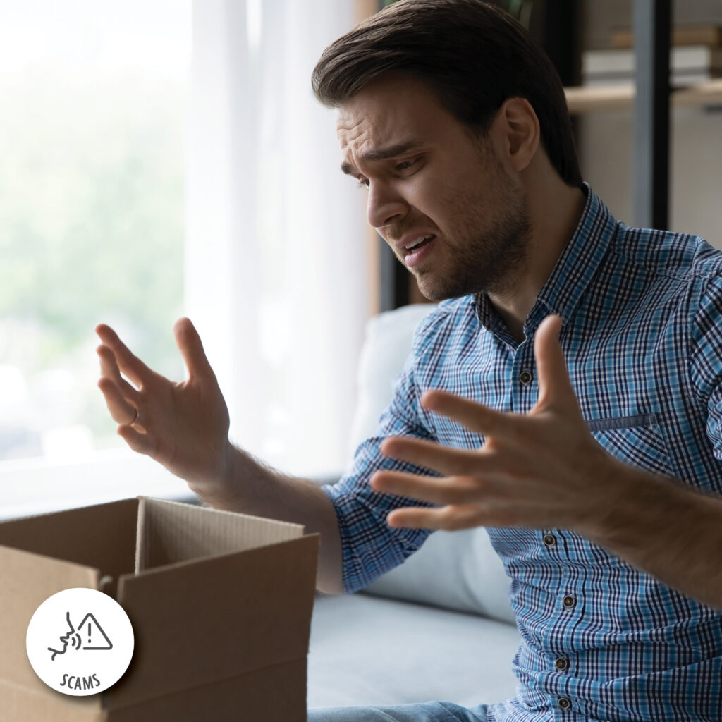 Unhappy man frustrated by wrong order online shopping or damaged package, bad delivery service, upset confused Caucasian customer opening unpacking parcel, cardboard box, sitting on couch at home.