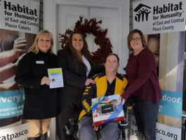 Image of SACFCU employees delivering a housewarming gift at the Habitat For Humanity Home Deciation in Dade City, FL.
