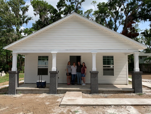 SACFCU Employees on the front porch of the Habitat Home that they helped paint