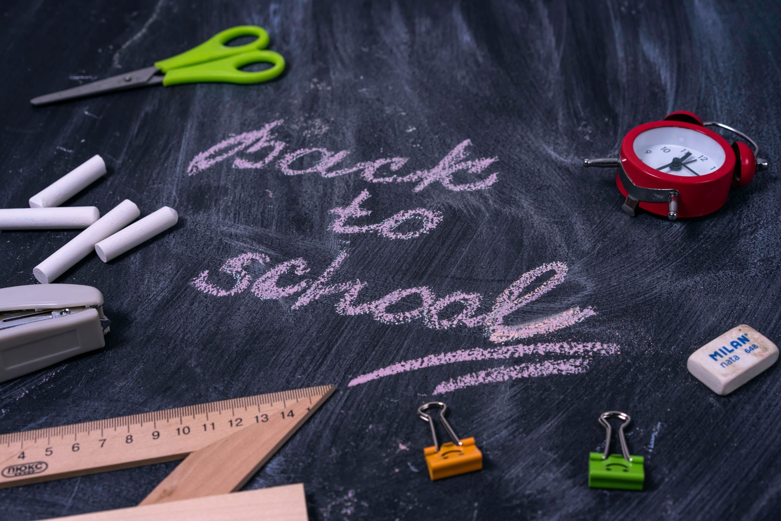 Chalk board with school supplies and the words back to school written on it.