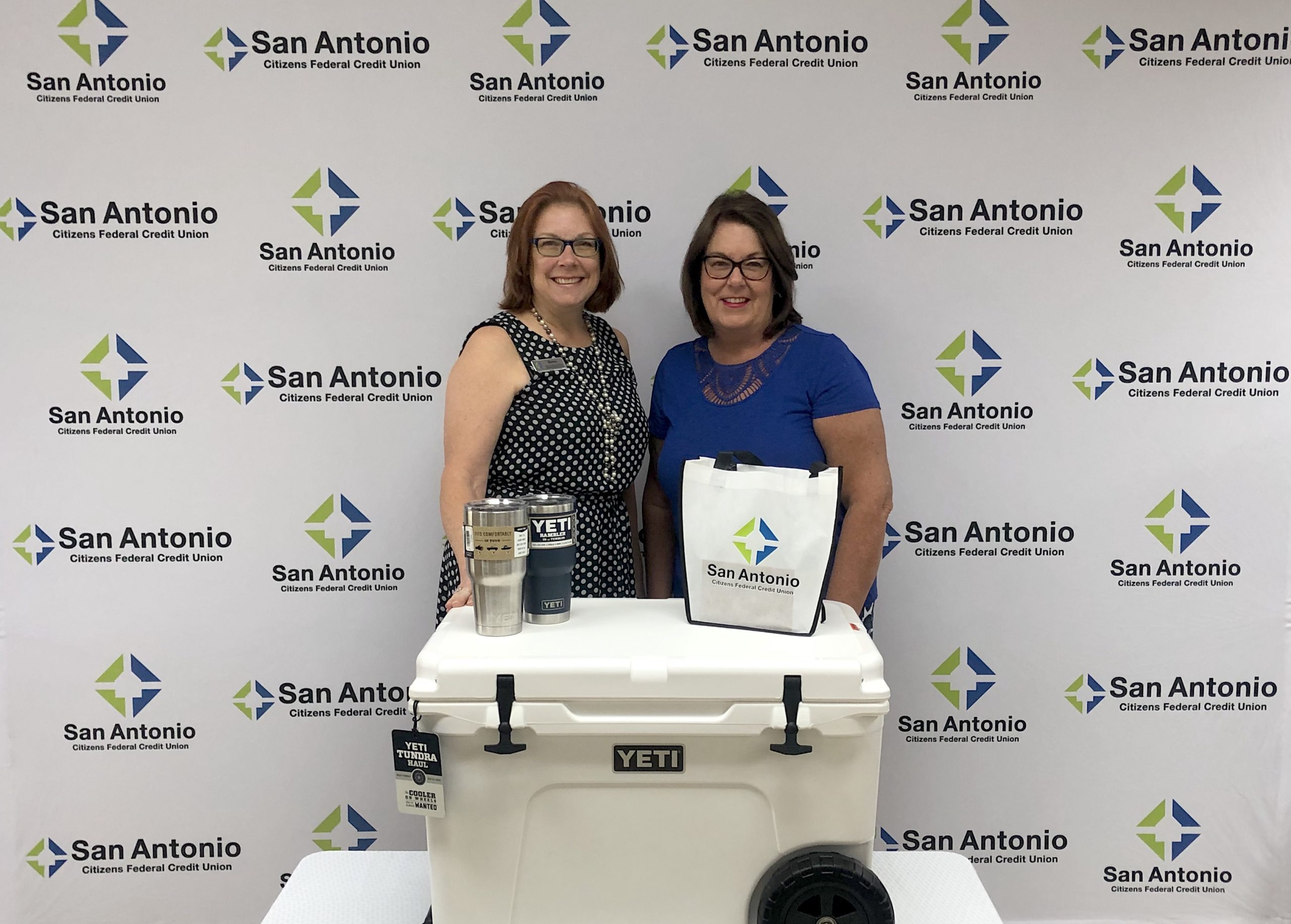 Winner of an SACFCU employee presenting a Yeti Cooler to the 2020 eStatement Contest winner.