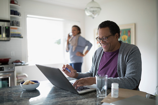 Man sitting in front of a computer smiling