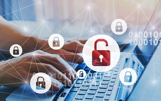 Image of a person on a laptop with security symbols scattered around the image.