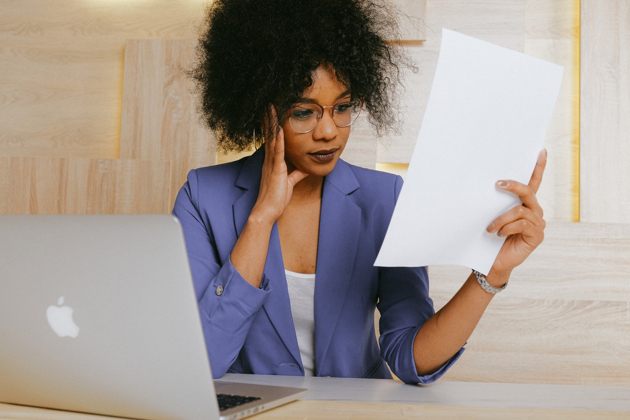 Woman sitting in front of her computer finishing her taxes.