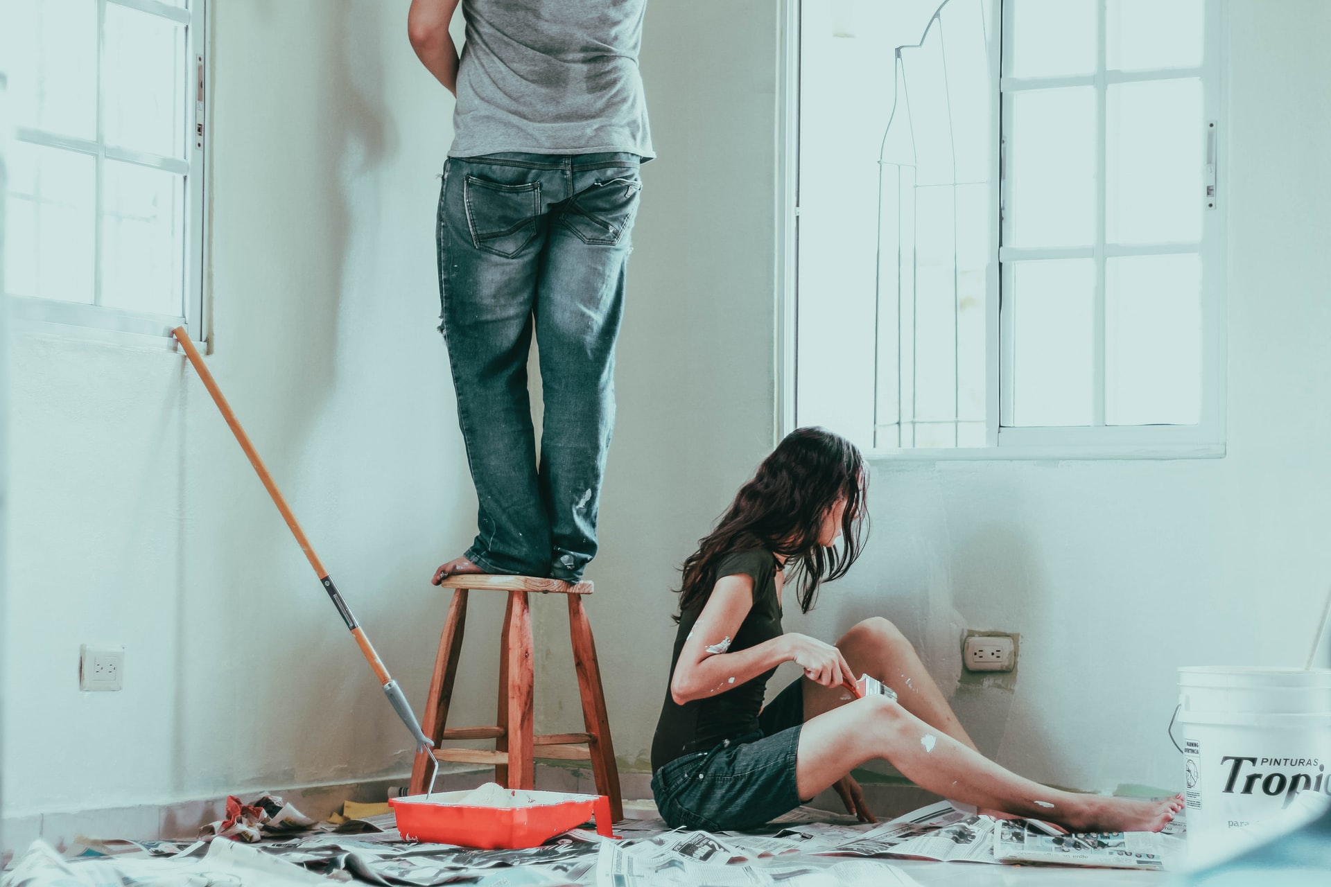 Image of a couple painting a room in their house